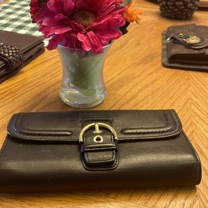 Coach black wallet with 14 card slots, including photo ID slot.